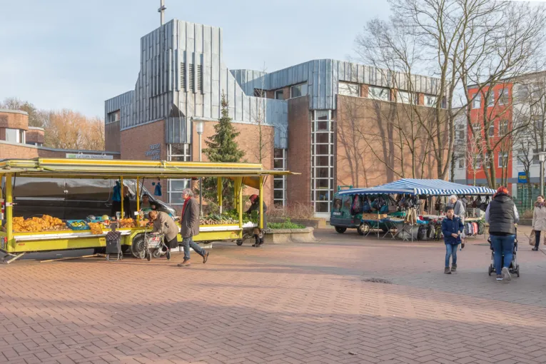 Menschen laufen &uuml;ber den Wochenmarkt in Gro&szlig;-Buchholz.